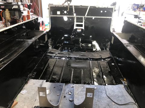 1992 Jeep Wrangler - Jeep CJ interior undergoing restoration with fresh black undercoating on the floor.