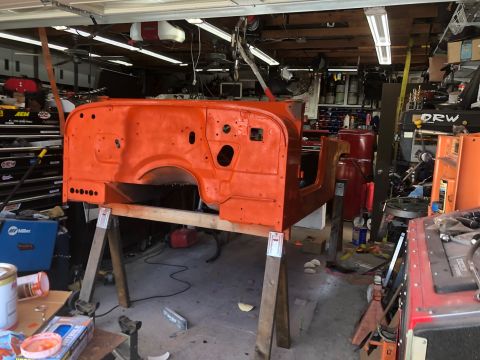 1992 Jeep Wrangler - The body tub of a Jeep CJ-7 is prepped for paint in a workshop setting.
