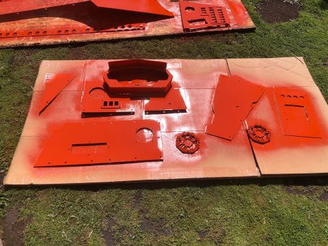1992 Jeep Wrangler - Various car interior parts, including a dashboard housing, are laid out and spray painted orange.