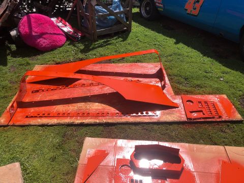 1992 Jeep Wrangler - Vehicle body panels are laid out on the grass, some are freshly painted orange.