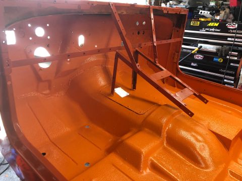 1992 Jeep Wrangler - The interior of a vehicle body is shown after being painted orange, with metal bracing installed for restoration.