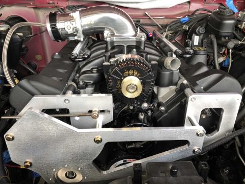 1992 Ford Crown Victoria - Close-up view of a modified engine bay, a polished intake system and a black alternator.