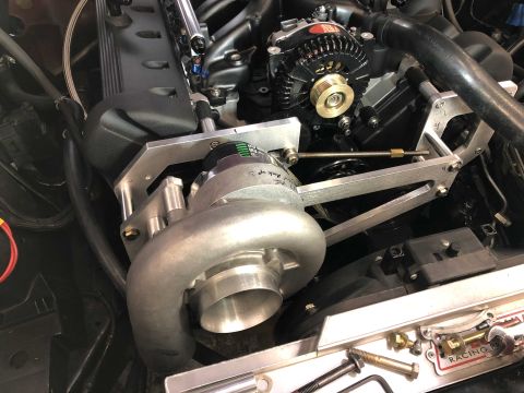 1992 Ford Crown Victoria - Close-up view of a custom turbocharger installation on an engine, showing various mechanical components.