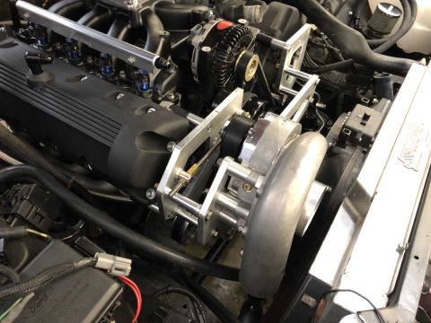 1992 Ford Crown Victoria - Close-up view of a modified engine bay, highlighting a supercharger and associated components.