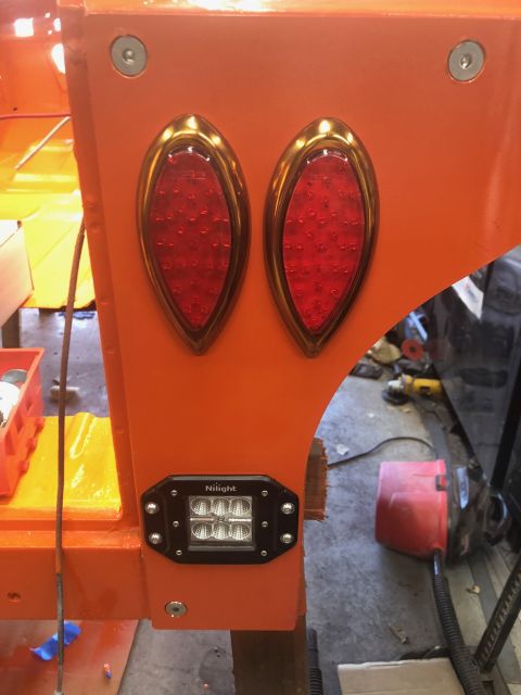 1992 Jeep Wrangler - Close-up of aftermarket tail lights and an LED light bar mounted on an orange panel.