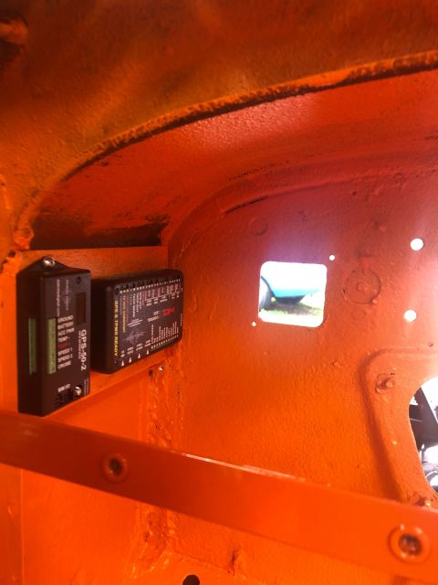 1992 Jeep Wrangler - Two electronic modules, one labeled GPS-50-2, are installed inside the orange interior of a vehicle.