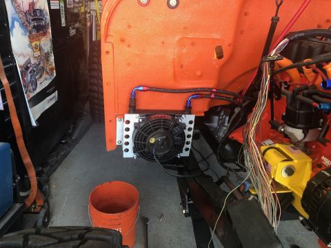 1992 Jeep Wrangler - An engine bay shows an installed oil cooler and fan, with a complex wiring harness visible.