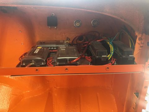 1992 Jeep Wrangler - Custom electrical fuse box and wiring installed in an orange compartment, likely part of a vehicle's interior.