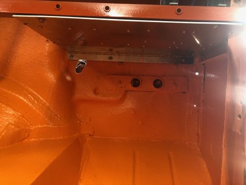 1992 Jeep Wrangler - Interior of a vehicle, painted orange, with visible metal bracing and mounting points.