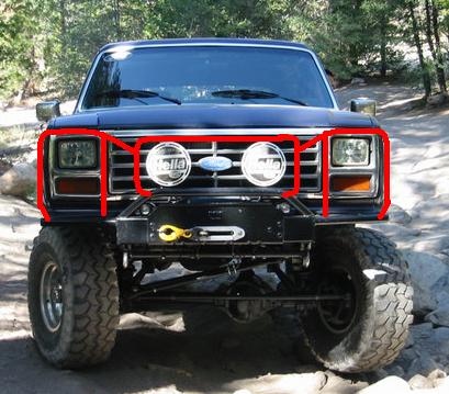 1985 Ford Bronco - This Ford Bronco features aftermarket Hella lights and a winch mounted on a custom bumper. The vehicle's body style suggests it is from the…