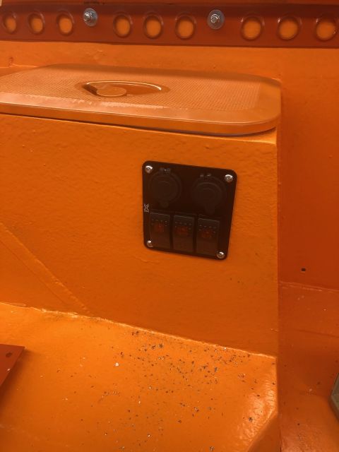 1992 Jeep Wrangler - This image shows a custom electrical panel with switches and power outlets installed in a vehicle's interior.