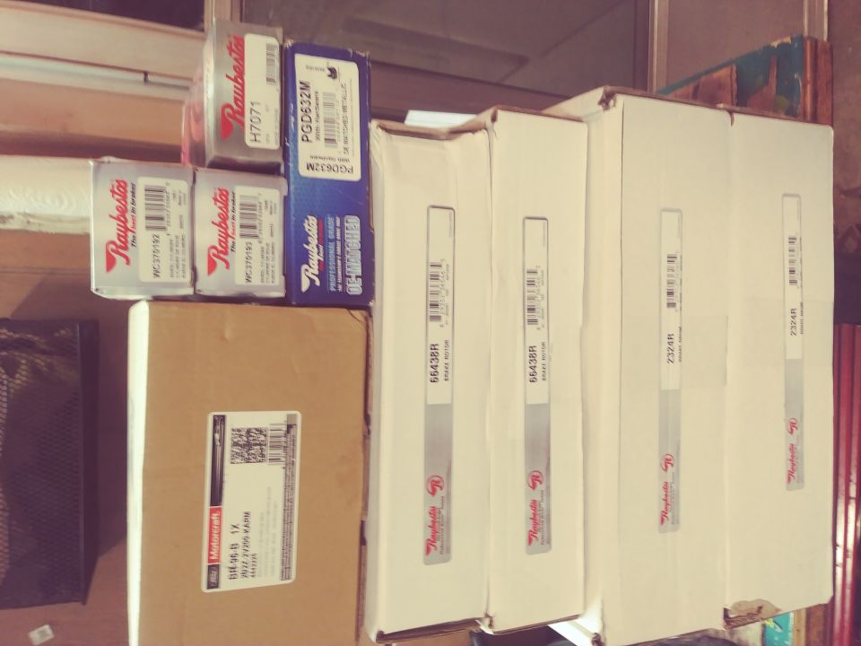 Boxes of Raybestos and other brake parts stacked, one box labeled "Ford Motorcraft 04-96 B 1X"