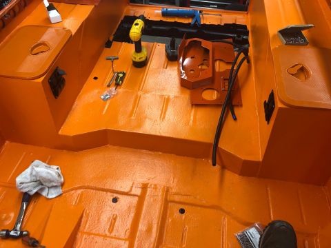 1992 Jeep Wrangler - The interior floor of a vehicle, painted bright orange, is shown with various tools laid out, suggesting ongoing work or restoration.