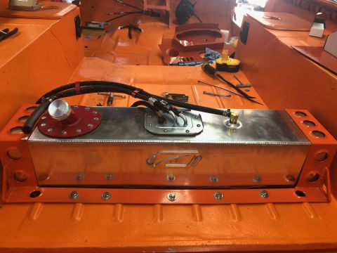 1992 Jeep Wrangler - An aftermarket aluminum fuel tank is installed in the orange interior of a vehicle.