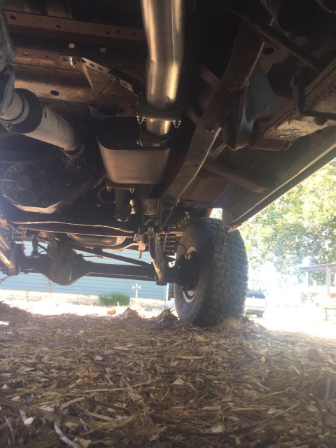 1979 Ford Bronco - The photo shows the underside of a vehicle, focusing on the exhaust system and suspension parts.