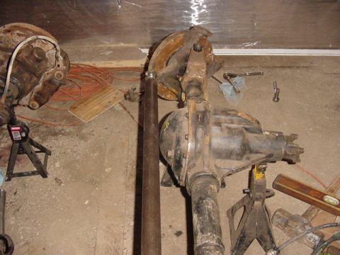 1992 Ford Bronco - A differential axle assembly is shown supported by jack stands in a workshop environment.