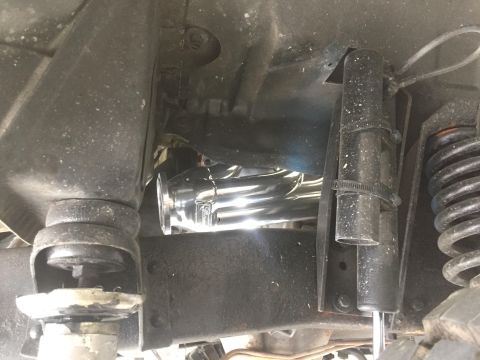 1979 Ford Bronco - Undercarriage view showing chrome exhaust headers and suspension components, likely from a classic truck or SUV.