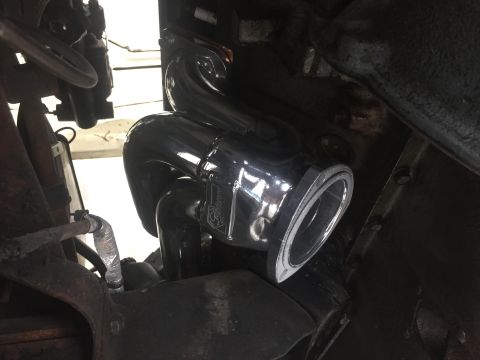 1979 Ford Bronco - Close-up of a chrome exhaust pipe and manifold assembly, likely a custom part.