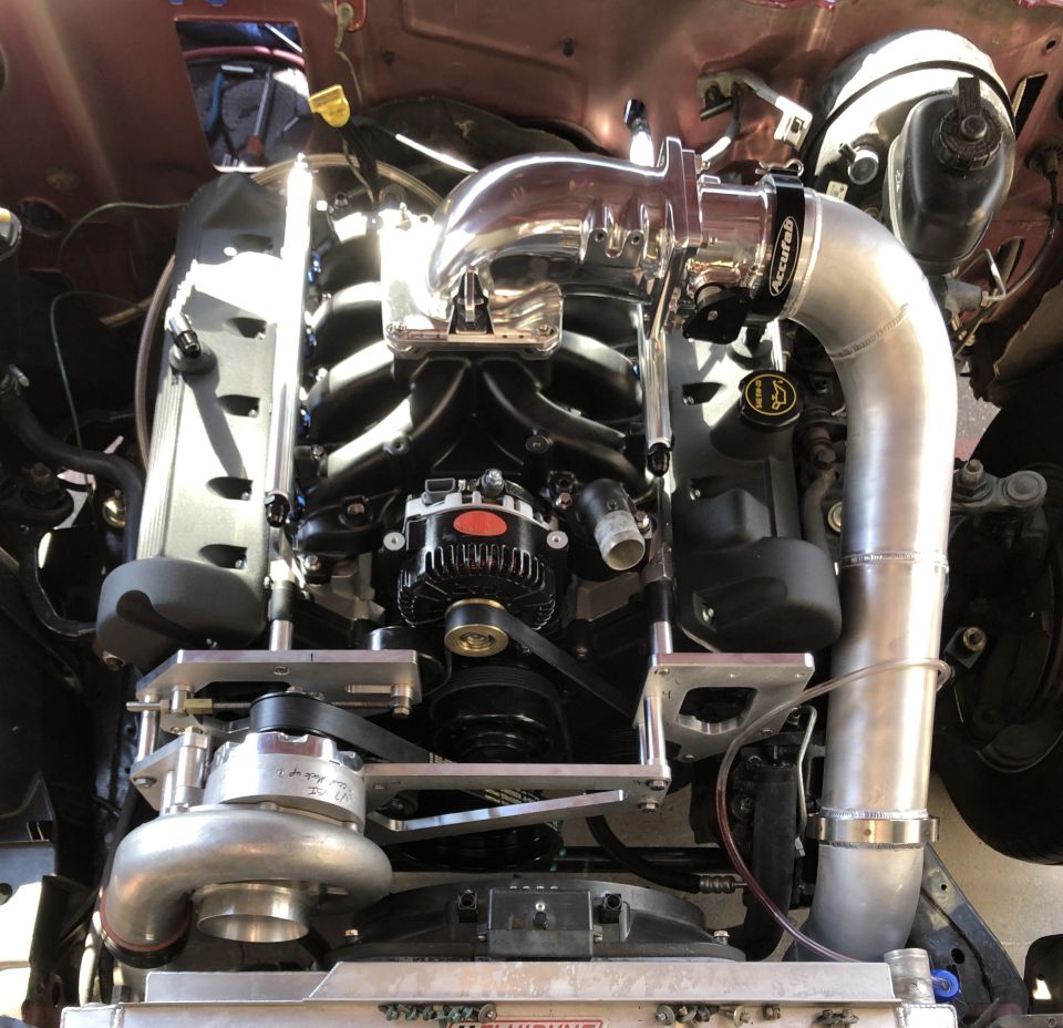 Engine bay with turbocharger and custom intake piping