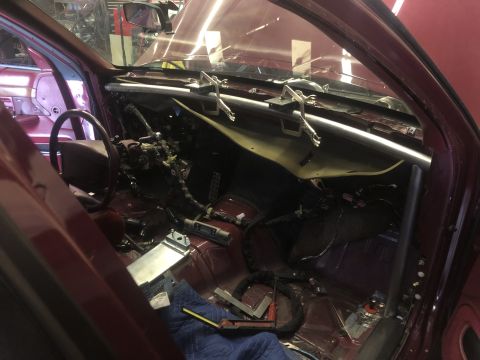 1992 Ford Crown Victoria - The interior of a car is being worked on, with the dashboard disassembled and wiring exposed.