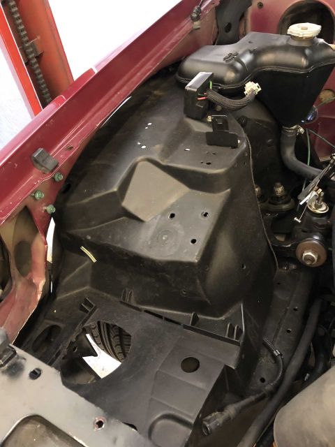1992 Ford Crown Victoria - Close-up view of the fender liner and associated components within the engine bay.