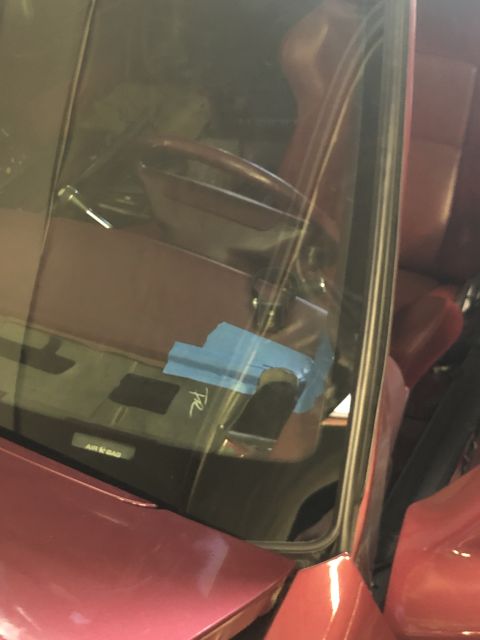 1992 Ford Crown Victoria - Interior view of a red car, showing the dashboard with blue tape and an 'AIR BAG' label visible.