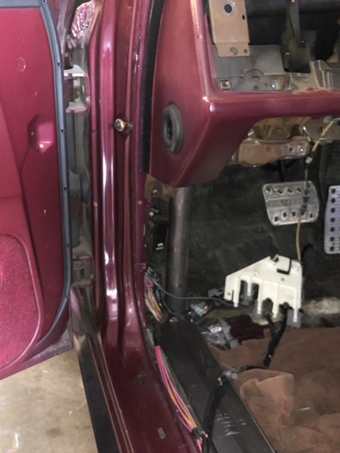 1992 Ford Crown Victoria - The interior of a maroon 1992 Ford Crown Victoria shows exposed wiring and disassembled dashboard components.