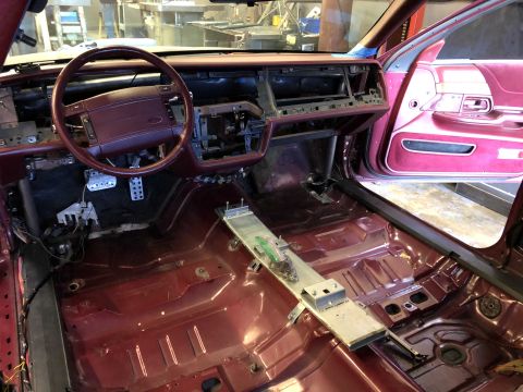 1992 Ford Crown Victoria - The interior of a 1992 Ford Crown Victoria shows a disassembled dashboard and maroon carpeting.