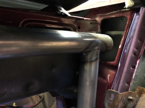 1992 Ford Crown Victoria - Welded roll cage tubing is visible inside a vehicle's interior structure.