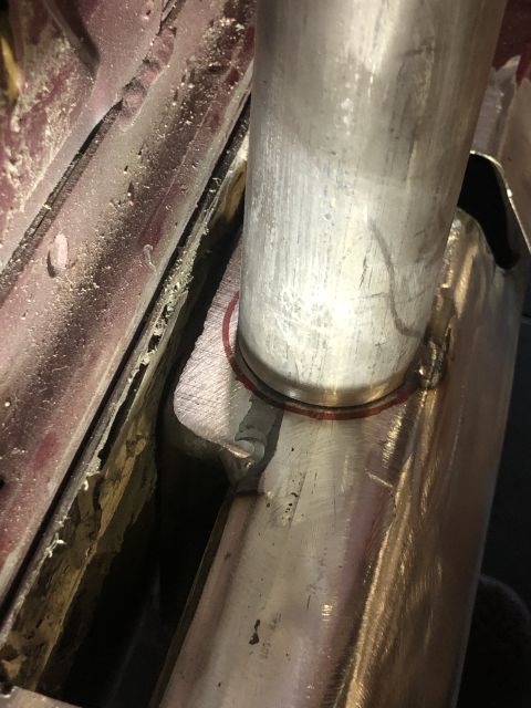 1992 Ford Crown Victoria - Welding detail on an exhaust pipe, showing metalwork and a red painted surface.