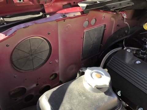 1992 Ford Crown Victoria - Close-up view of the engine bay firewall, showing the coolant reservoir and various engine components.