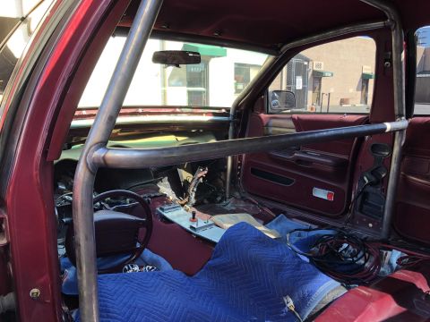 1992 Ford Crown Victoria - The interior of the vehicle shows a custom roll cage and the seats are covered with protective blankets.