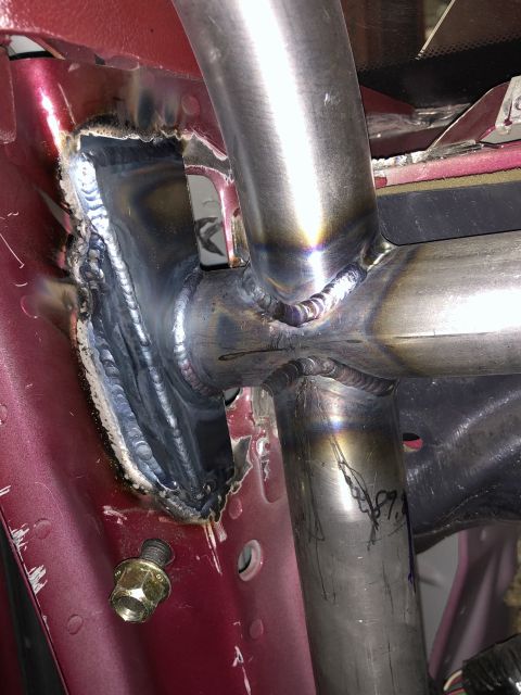 1992 Ford Crown Victoria - Roll cage installation showing welds and mounting points on the vehicle's interior structure.