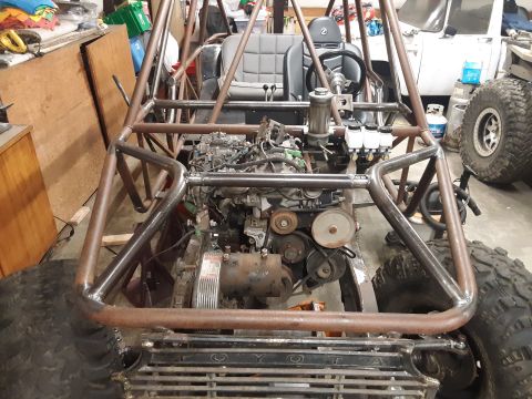 1985 Toyota Hilux - Custom buggy interior and engine bay are exposed, with large off-road tires on the sides.