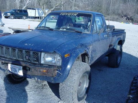 1992 Ford Bronco - This blue Toyota pickup truck features a lifted suspension and large off-road tires, suggesting it is modified for off-road use.