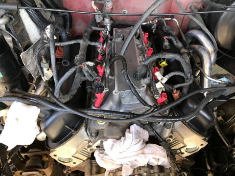 2000 Ford Explorer - Engine components with red fuel injectors and black wiring harnesses are visible in this close-up view.
