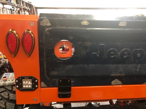 1992 Jeep Wrangler - Close-up of a Jeep tailgate with a circular cutout and the Jeep logo is visible.