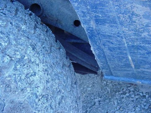 1992 Ford Bronco - Close-up view of a vehicle's undercarriage, showing a tire and body panel.