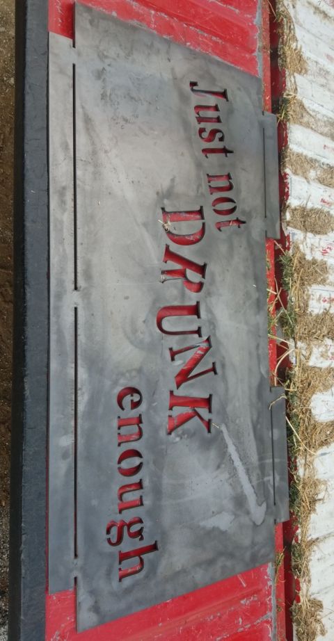 1996 Dodge 1500 - A metal sign with the words 'Just not DRUNK enough' cut out, along with a Nike swoosh, is attached to a red surface.