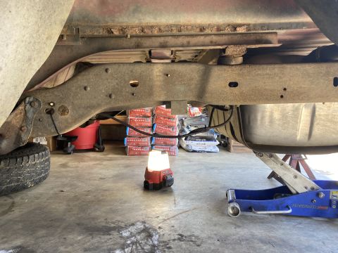 1994 Ford Bronco - The underside of a truck is shown, with a fuel tank and frame components visible.