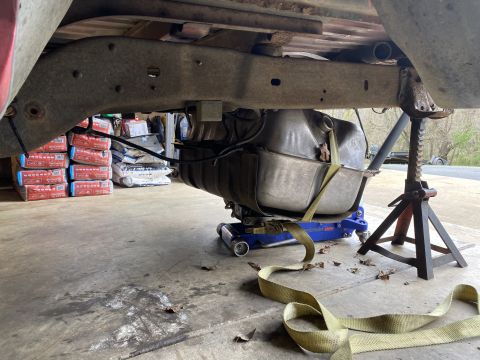 1994 Ford Bronco - Underbody view of a vehicle with its fuel tank being serviced.