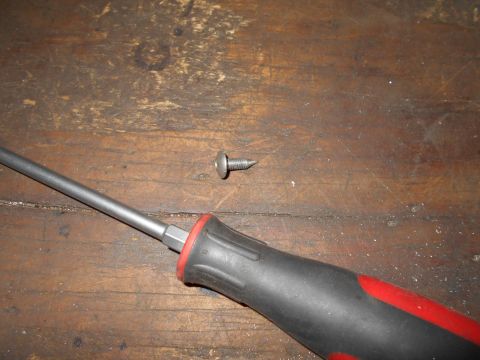 1992 Ford Bronco - A screwdriver and a screw are shown on a wooden surface.