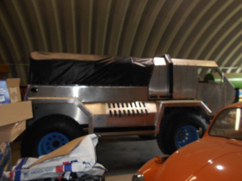 1992 Ford Bronco - Custom truck with aluminum body and canvas top is parked next to an orange car.