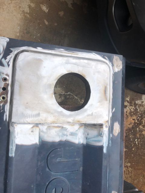 1992 Jeep Wrangler - This photo shows a section of a Jeep tailgate that has undergone metal repair, including welding and grinding around a circular opening.