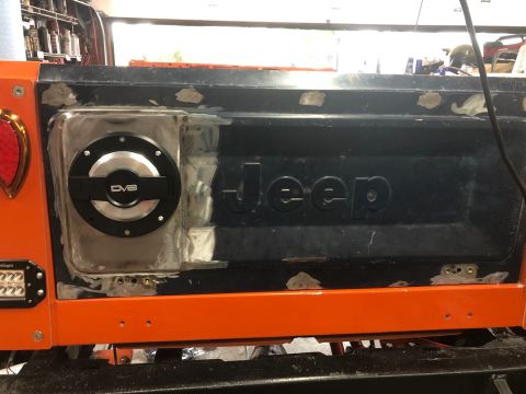 1992 Jeep Wrangler - Tailgate of a Jeep undergoing body work, a custom fuel door installation.