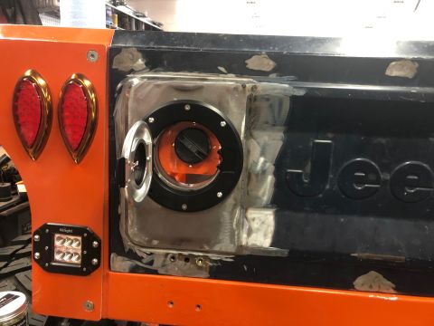 1992 Jeep Wrangler - Close-up of a Jeep's rear, showing modifications to the tailgate and taillight area.