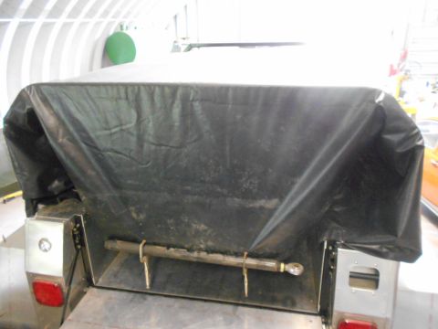 1992 Ford Bronco - A close-up view of a trailer hitch assembly, partially obscured by a black tarp.