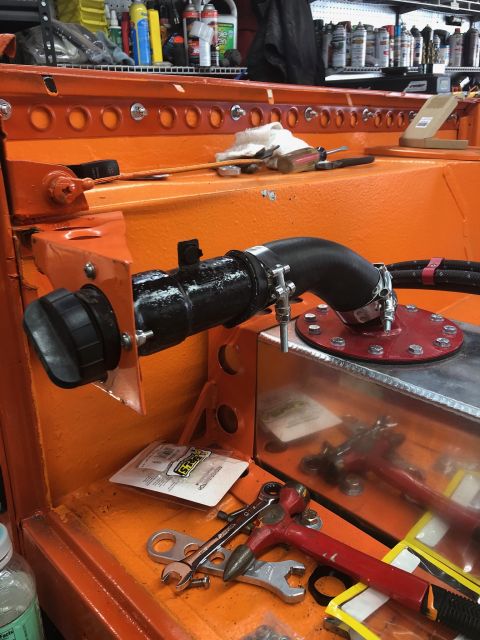 1992 Jeep Wrangler - Close-up of automotive parts and tools on an orange surface, likely in a workshop.