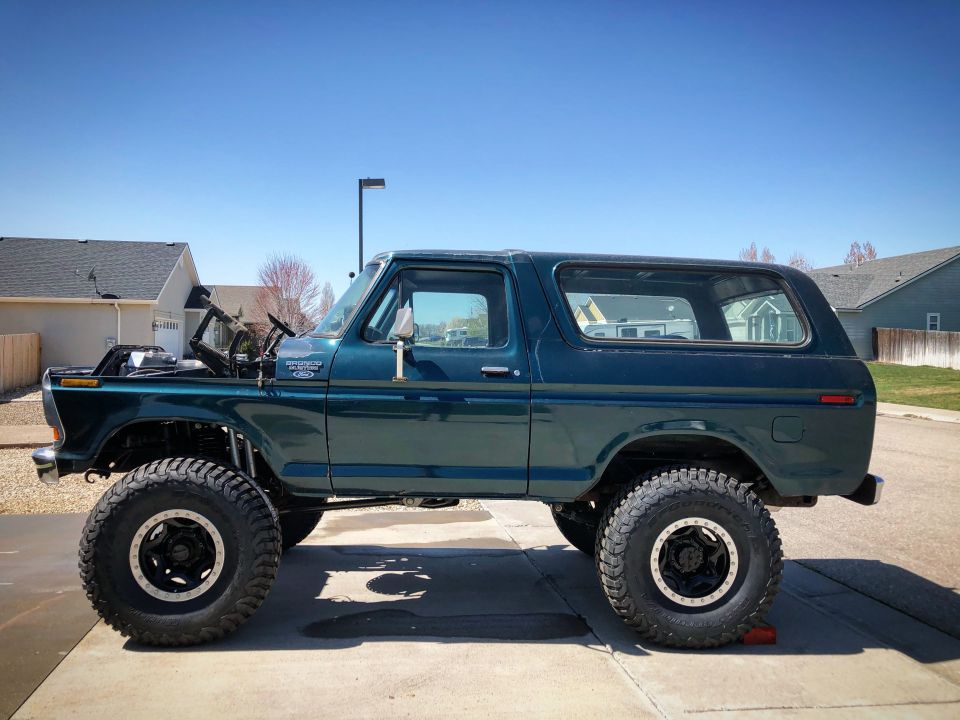 1979 Ford Bronco lifted with large tires, hood open, side view