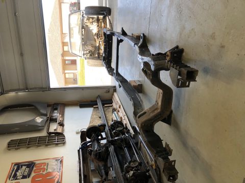 1979 Ford Bronco - A vehicle frame and various parts are visible in a garage setting, suggesting a project or repair.